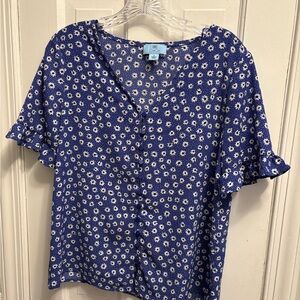 Blue blouse with white flowers.